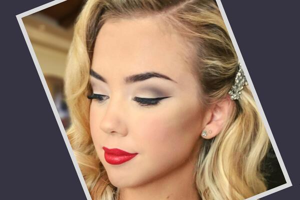 Model wearing red lip and defined liner