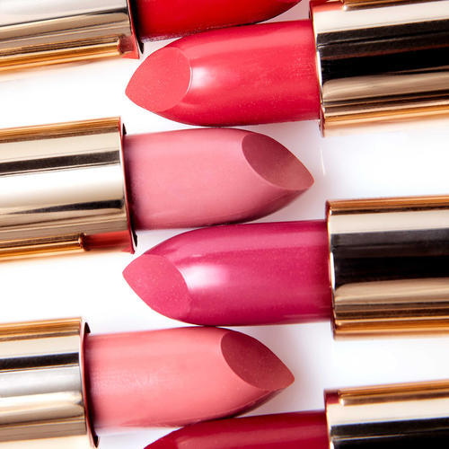 Close up of different shades of pink and red lipsticks 