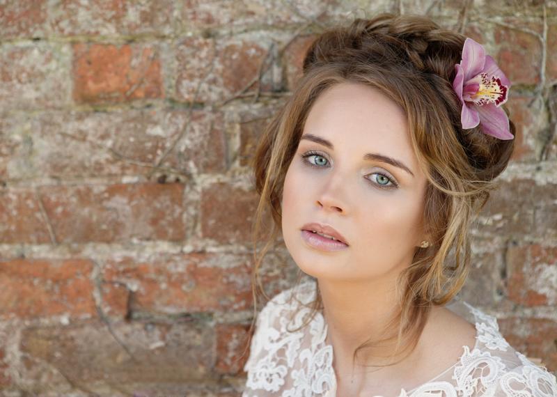 Boho bridal makeup with romantic updo and large braid